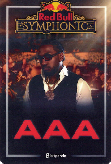 Stylized event pass for Red Bull Symphonic featuring a man in sunglasses and jewelry against a blurred orchestra background and large red AAA text.